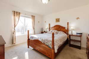 Bedroom with light carpet and baseboards