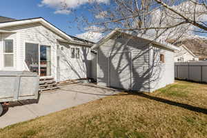 Rear view of house with a patio, a shed, and entry steps