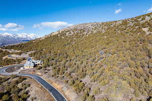 Aerial view of property and surrounding area featuring a mountain backdrop