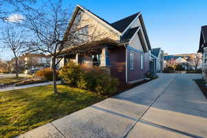 View of side of property featuring a yard