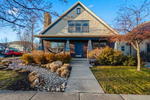 View of front of property featuring a chimney and a front yard
