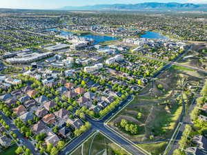 Aerial view of property's location with a water and mountain view and nearby suburban area