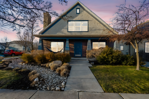 View of front of home featuring a lawn and a chimney