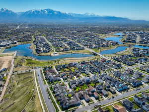 Aerial overview of property's location featuring nearby suburban area and a water and mountain view