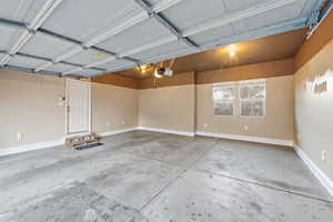 Garage featuring baseboards