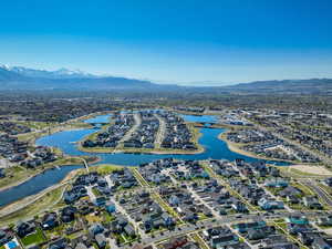 Aerial overview of property's location with a water and mountain view and nearby suburban area