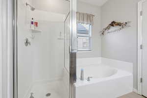 Full bath with a bath, a shower stall, and tile patterned flooring