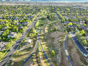 Aerial view of property and surrounding area with nearby suburban area