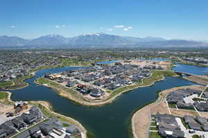 Aerial view of property and surrounding area with nearby suburban area and a water and mountain view