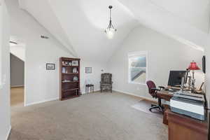 Office featuring light colored carpet and vaulted ceiling
