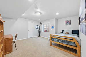 Bedroom with light carpet and recessed lighting