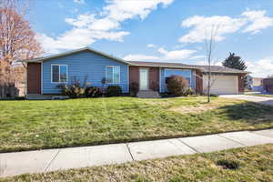 Single story home featuring brick siding, an attached garage, and concrete driveway