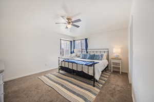 Bedroom with a ceiling fan and carpet floors