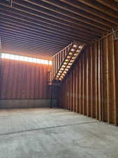 Misc room featuring unfinished concrete flooring