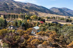 Aerial view of property and surrounding area featuring mountains