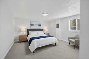 Bedroom featuring carpet floors, a textured ceiling, and electric panel Virtual staged