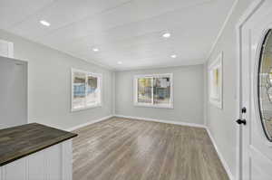 Unfurnished dining area with light wood finished floors and recessed lighting