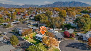 Aerial perspective of suburban area with property boundaries highlighted and mountains