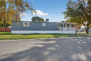 View of front of house with a front yard and covered porch
