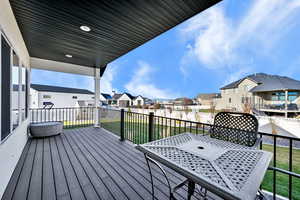 Deck with a residential view and a lawn