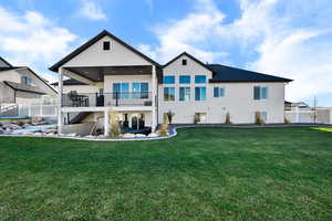 Back of house with a patio, stucco siding, and a balcony