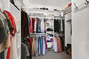 Spacious closet featuring carpet flooring
