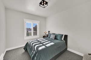 Carpeted bedroom featuring baseboards