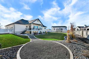 Back of property with stairs, a fenced backyard, and a patio