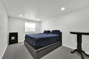 Carpeted bedroom featuring recessed lighting and a textured ceiling