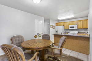 Dining room with light tile patterned flooring and baseboards