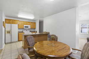 Dining area featuring baseboards and light tile patterned floors