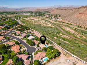 Aerial view of property's location with mountains and nearby suburban area