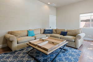 Living area with hardwood / wood-style floors and baseboards