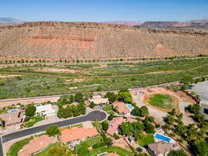 Aerial view of property's location featuring a mountainous background and rural landscape