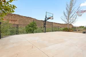 View of sport court with basketball court and a patio area