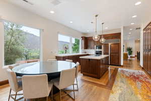 Kitchen featuring decorative light fixtures, a mountain view, recessed lighting, light wood-type flooring, and a kitchen island