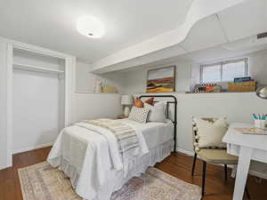 Bedroom featuring a closet and dark wood-type flooring
