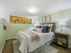 Bedroom featuring carpet floors and a textured ceiling