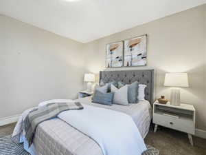 Bedroom featuring carpet flooring and baseboards