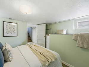 Bedroom featuring a textured ceiling