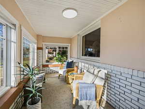 Sunroom with wooden ceiling and ornamental molding
