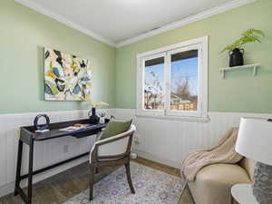 Office area with wainscoting, ornamental molding, and carpet flooring