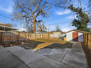 Fenced backyard with a storage shed