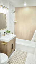 Bathroom with vanity, shower / bathtub combination, and a textured ceiling