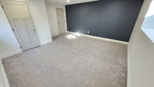 Unfurnished bedroom featuring carpet floors and baseboards
