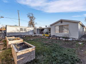 View of front of home featuring a garden, a front lawn, and a patio area