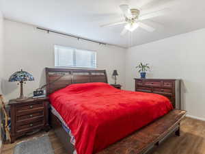 Bedroom with wood finished floors and ceiling fan