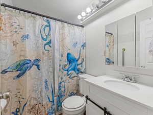 Full bath with vanity and shower / bath combination with curtain