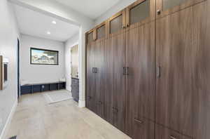 Mudroom featuring baseboards and recessed lighting