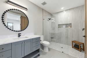 Full bathroom featuring vanity, a walk in shower, and light tile patterned floors